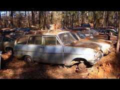 Junkyard in Cataula, GA, USA. Tons of rusty cars from the 1930es to the 2000